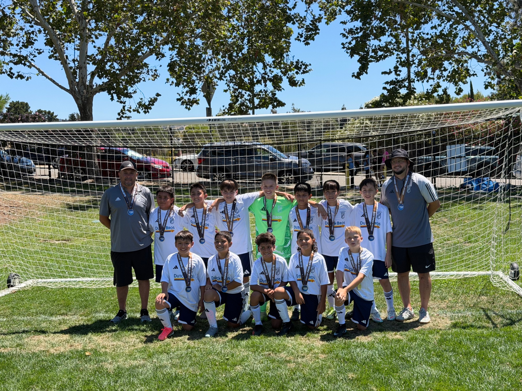 EC Revolution U11 Boys Blue team photo in front of the goal wearing Creek Cup finalist medals